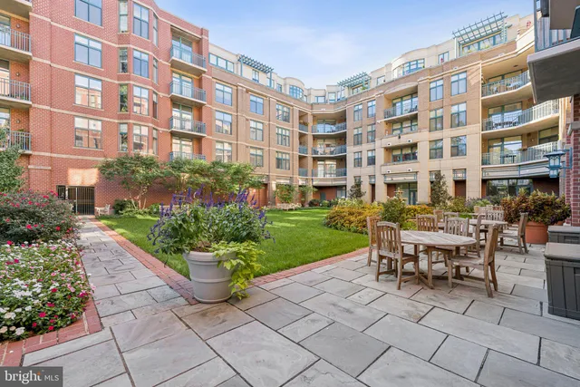 a swimming pool with outdoor seating and plants