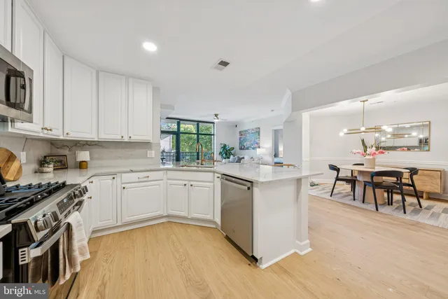 a kitchen with a sink and chairs