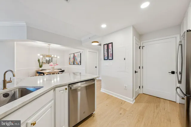 a kitchen with a sink cabinets and appliances