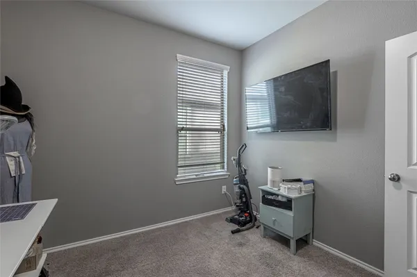 a room with a chair and a flat screen tv