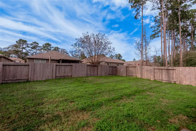 a view of a backyard with wooden fence