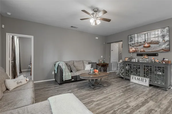 a living room with furniture and a chandelier