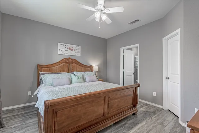 a bedroom with a bed and a chandelier
