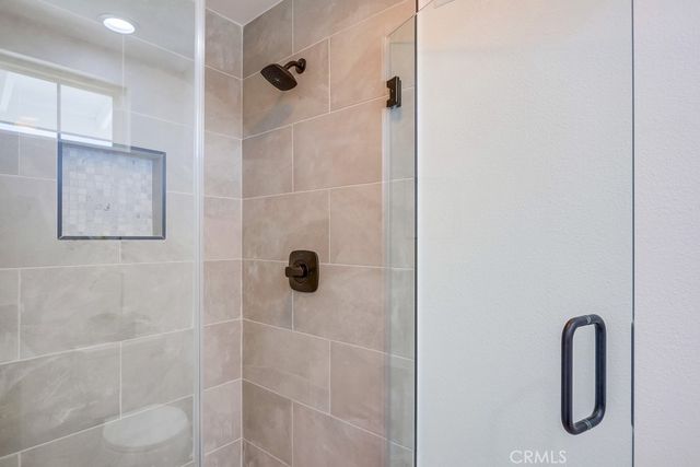 a bedroom with a sink and a mirror