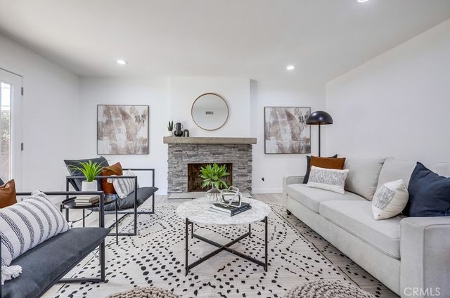 a living room with furniture a table and a fireplace