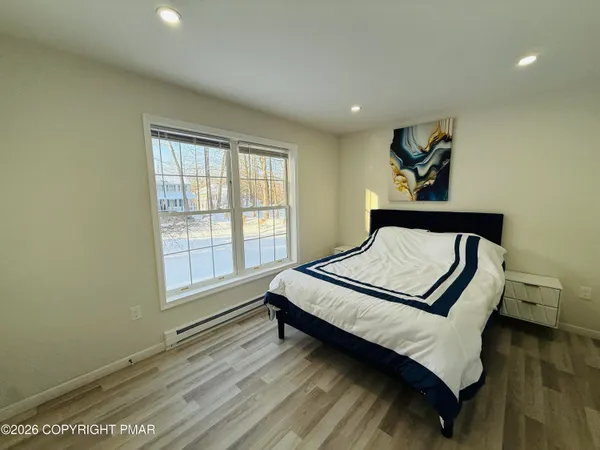 a bedroom with a bed and window