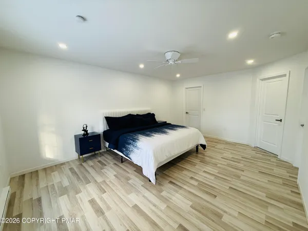 a spacious bedroom with a bed and a table