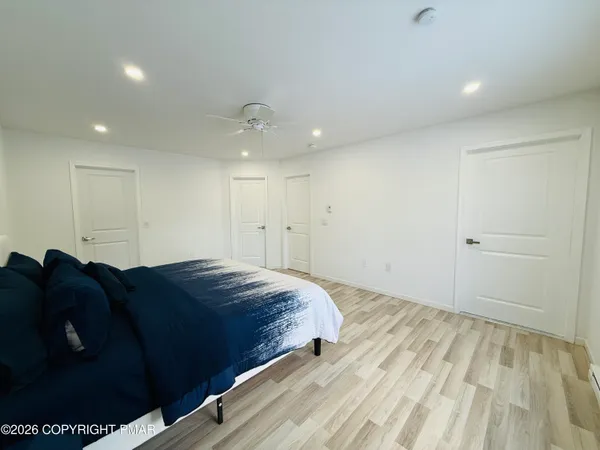 a spacious bedroom with a bed and a walk in closet
