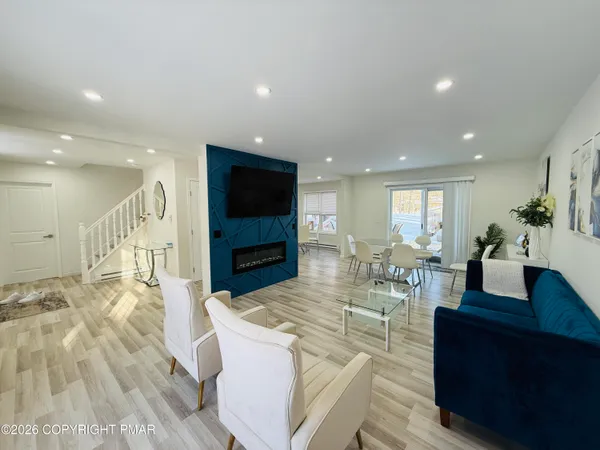 a living room with fireplace furniture and a flat screen tv