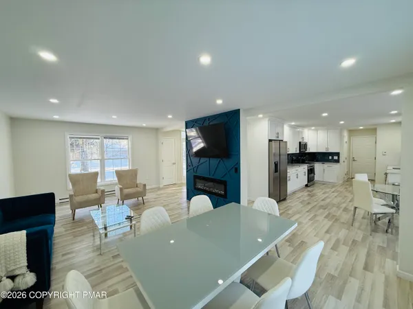 a living room with lots of furniture and kitchen view