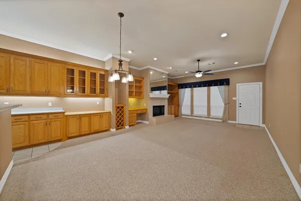 a view of an empty room with a kitchen