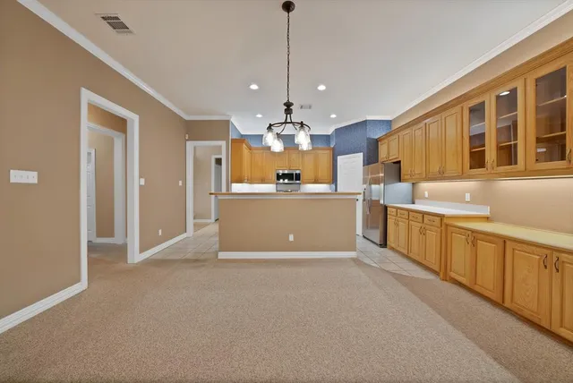 a view of a kitchen with a sink and cabinets