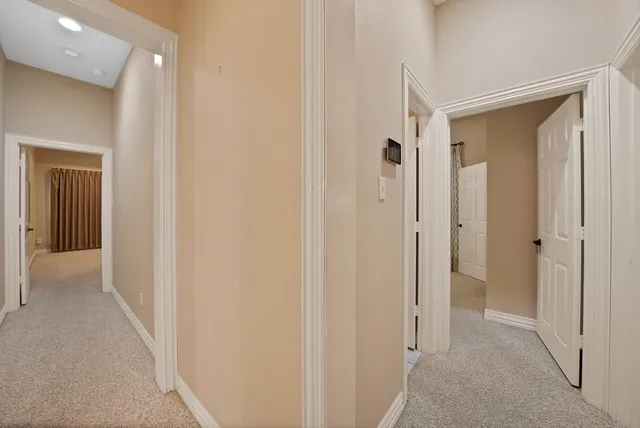 a view of a hallway with a wooden door