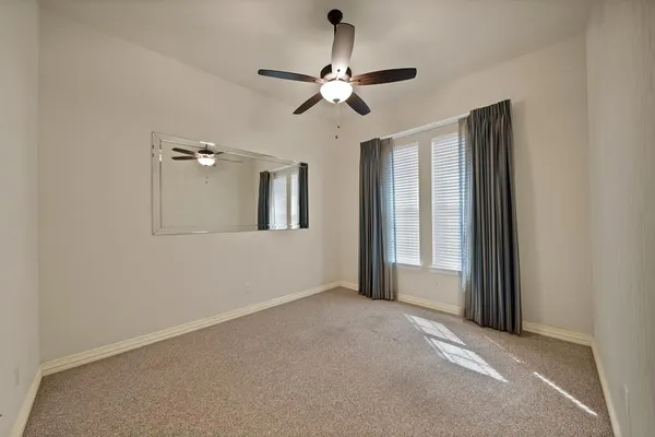 a view of a livingroom with a ceiling fan and window