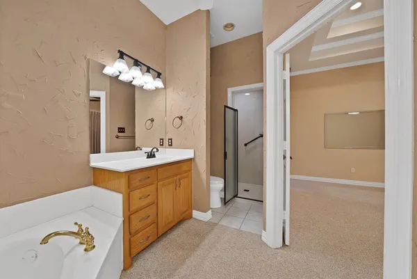 a spacious bathroom with a double vanity sink a mirror and shower