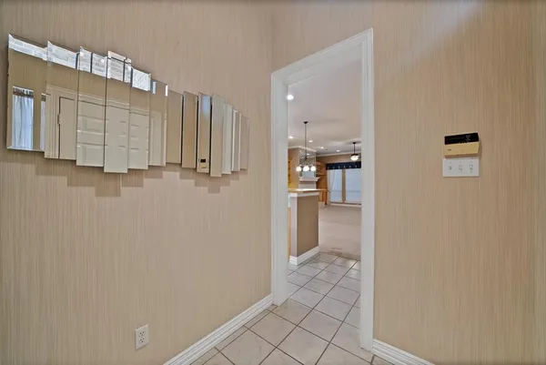 a view of a kitchen with refrigerator and wooden floor