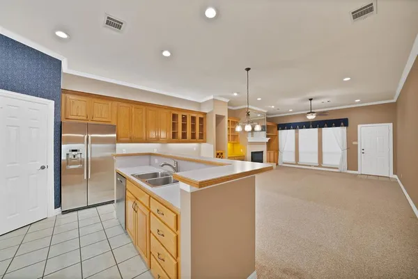 a kitchen that has a lot of cabinets in it and wooden floors