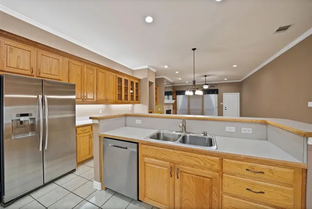 a kitchen with stainless steel appliances granite countertop a sink and refrigerator