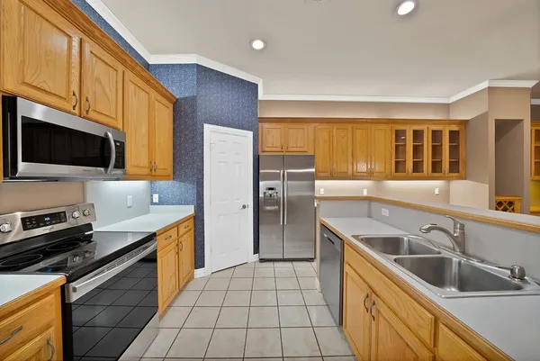 a kitchen that has a sink and a stove top oven