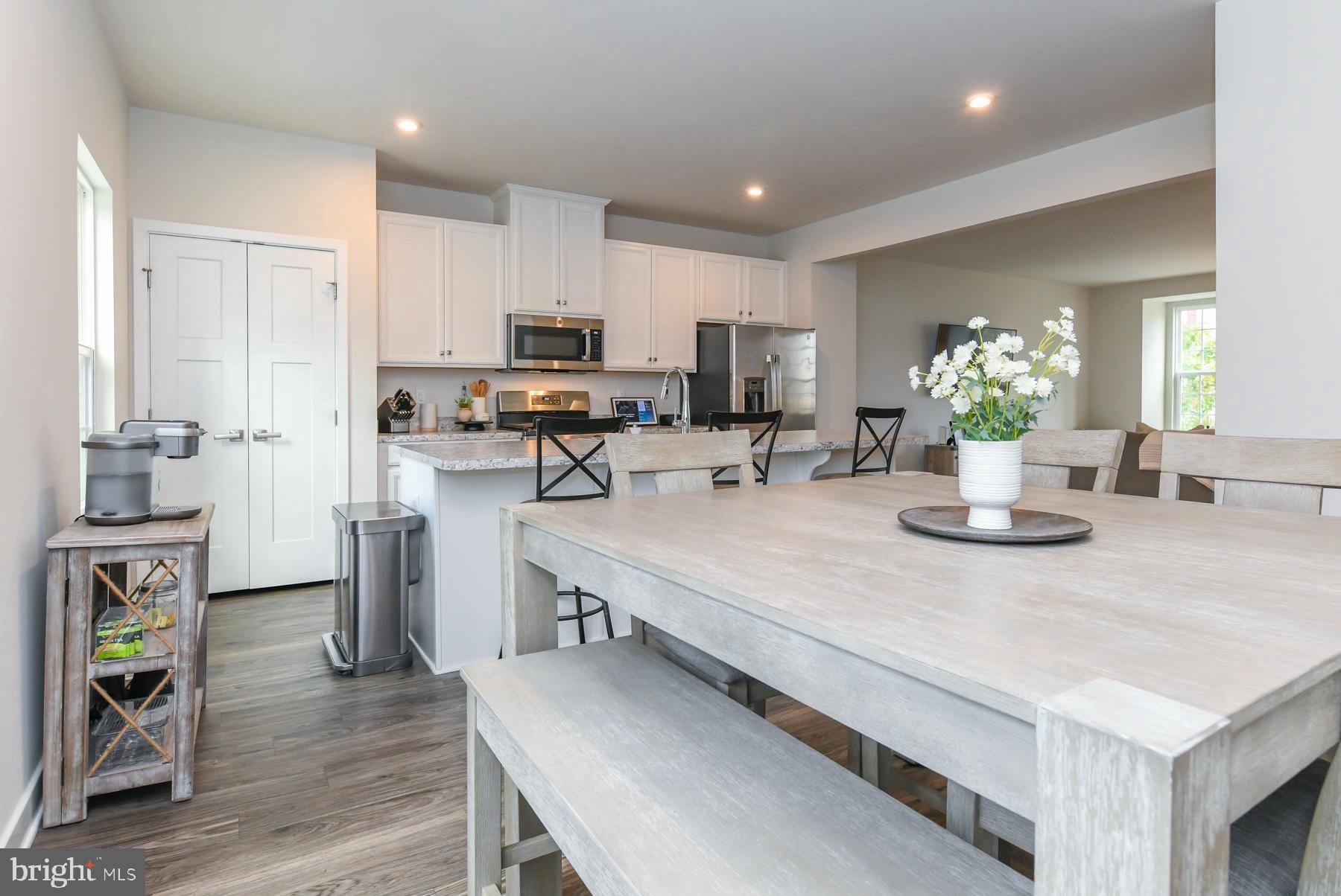 28 Peacock Circle Sewell, NJ 08080 - Photo 9 of 25 a kitchen with a table chairs refrigerator and microwave