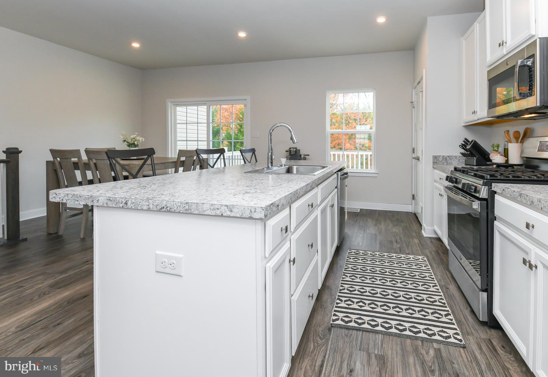 28 Peacock Circle Sewell, NJ 08080 - Photo 10 of 25 a kitchen with stainless steel appliances granite countertop a sink stove and cabinets