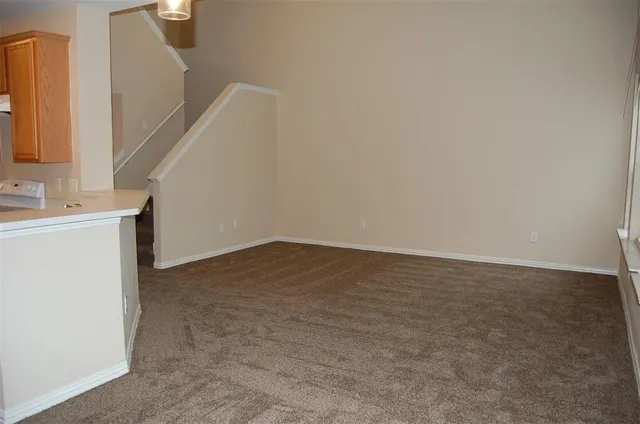 a view of an empty room with stairs