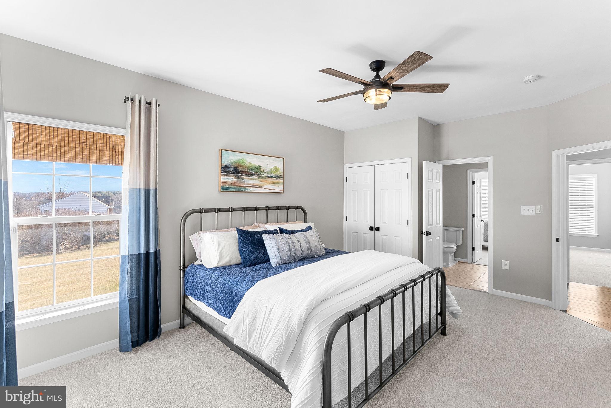 38590 Bettis Drive Hamilton, VA 20158 - Photo 57 of 97 a bedroom with a large bed and a ceiling fan