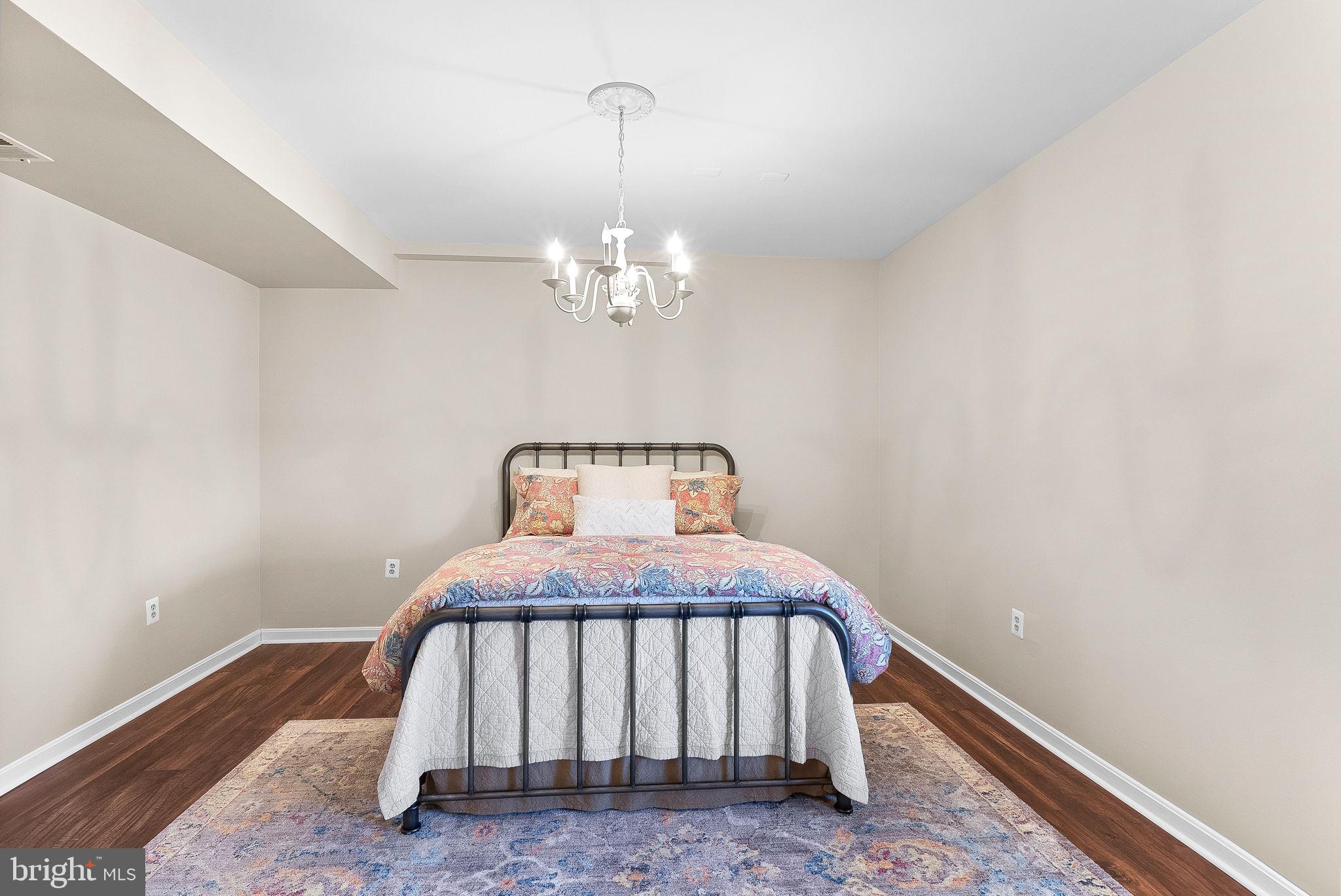 38590 Bettis Drive Hamilton, VA 20158 - Photo 71 of 97 a bedroom with a bed and wooden floor