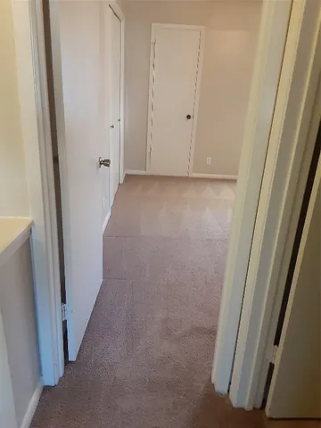 a view of an empty room with a fan