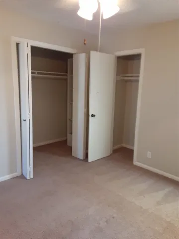 a view of walk in closet with empty racks