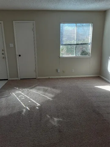 an empty room with a empty space and windows