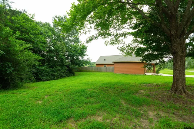 a view of a backyard with large trees