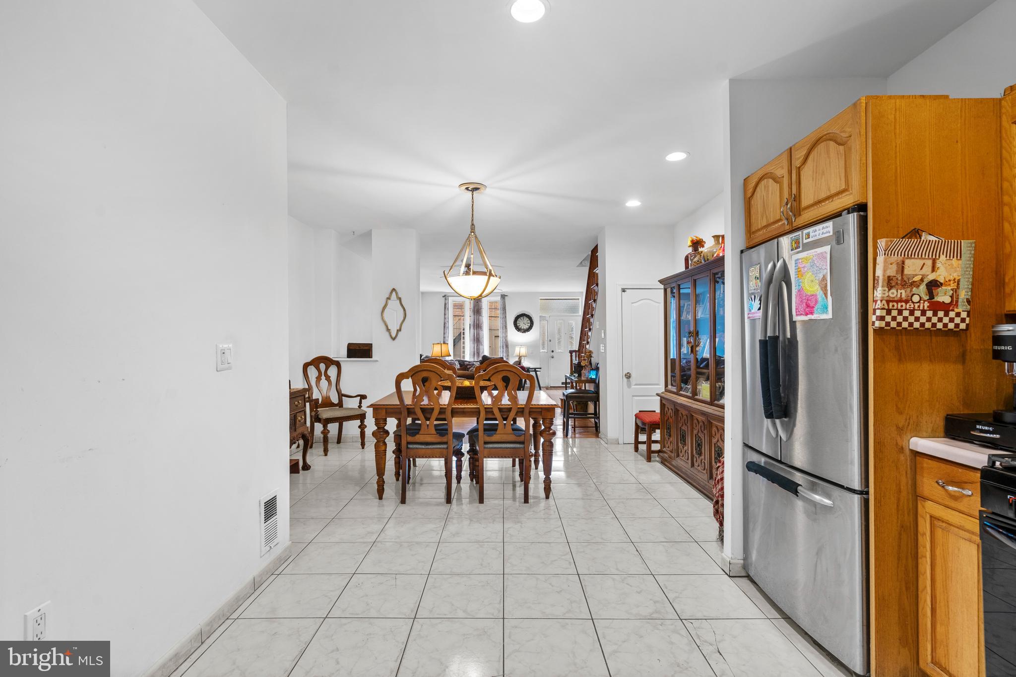 1605 Wolf Street Philadelphia, PA 19145 - Photo 18 of 40 a kitchen with stainless steel appliances a refrigerator and a dining table