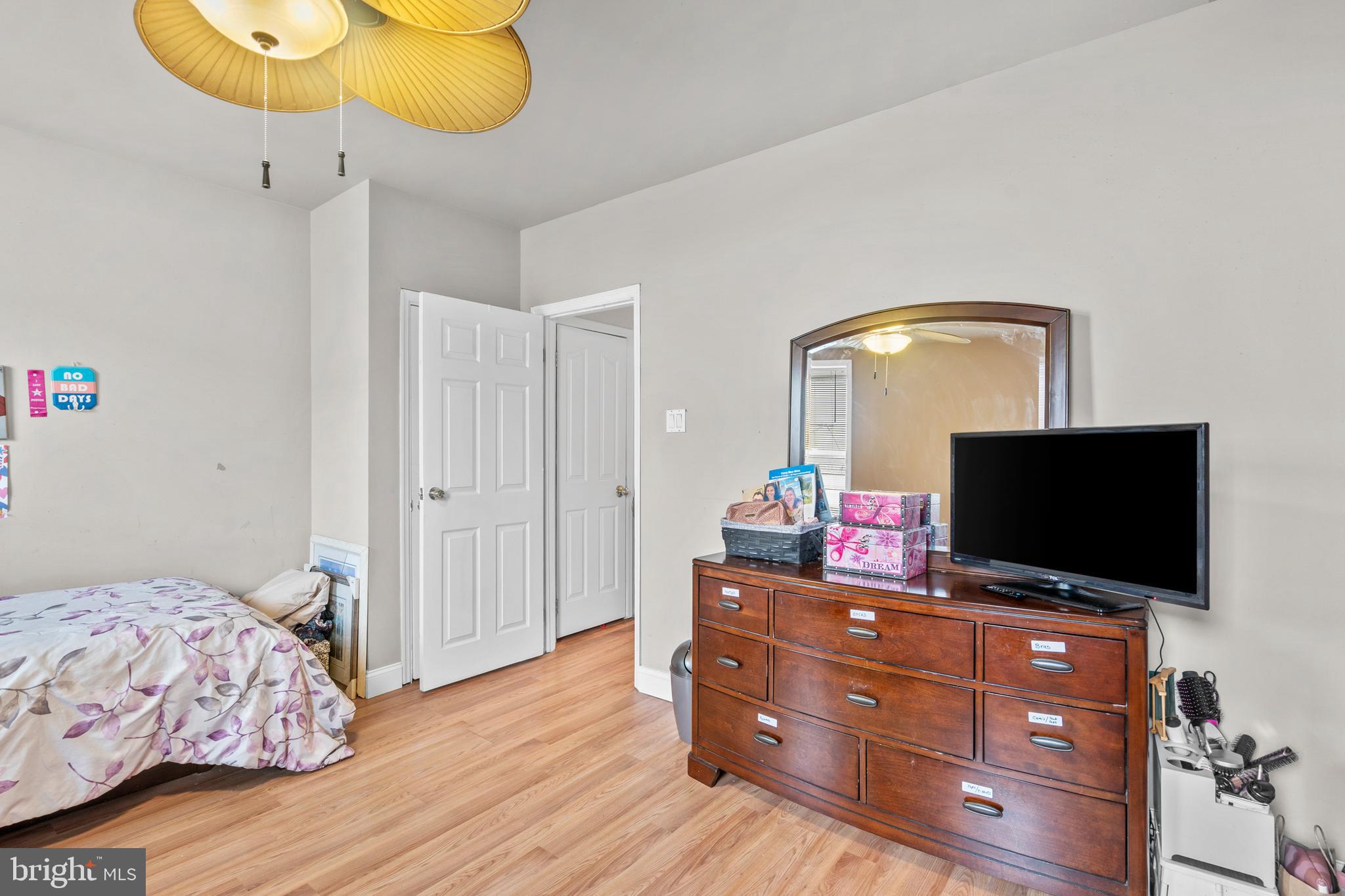 1605 Wolf Street Philadelphia, PA 19145 - Photo 22 of 40 a bedroom with a bed and wooden floor