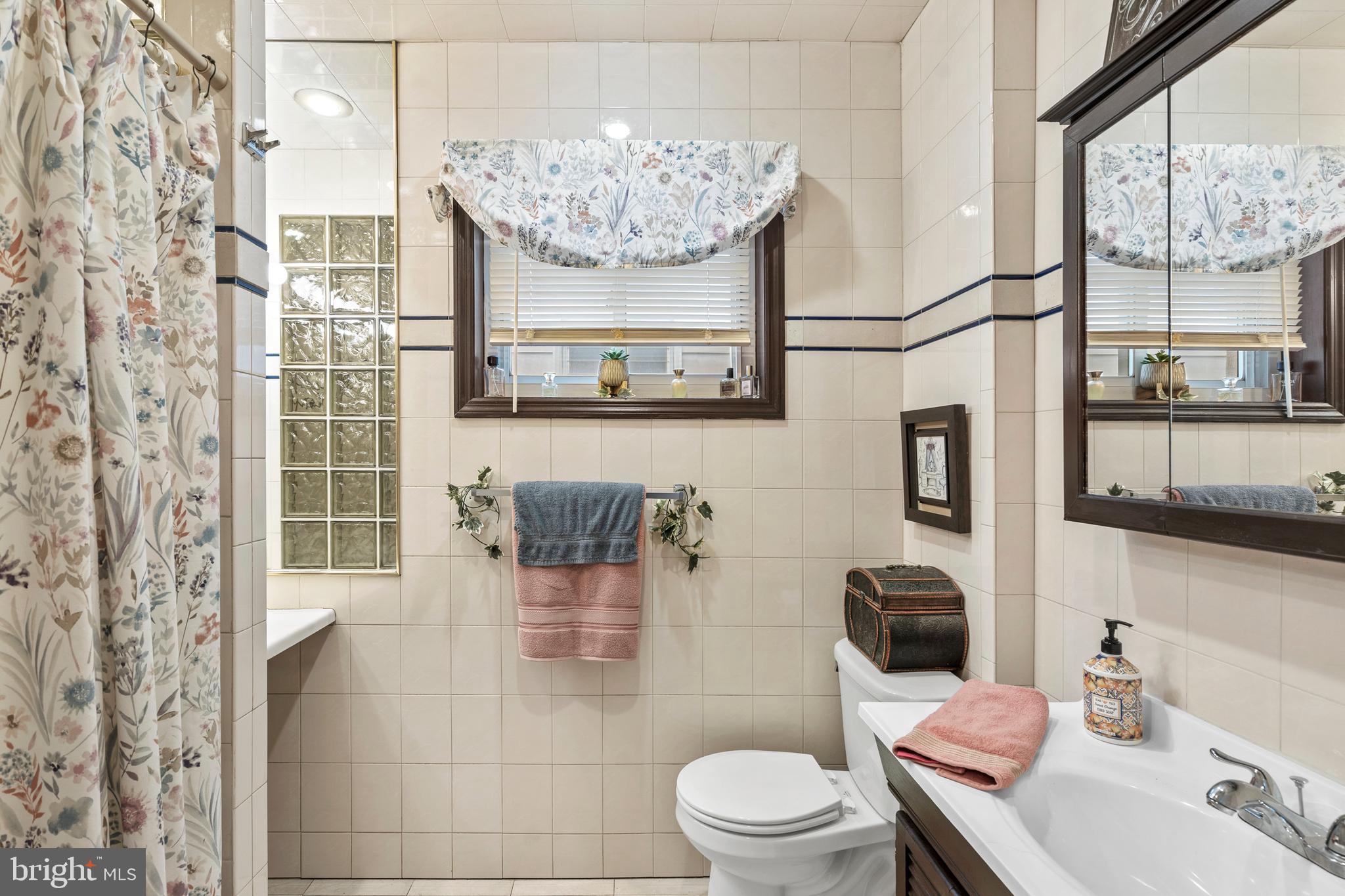 1605 Wolf Street Philadelphia, PA 19145 - Photo 29 of 40 a bathroom with a toilet sink and mirror