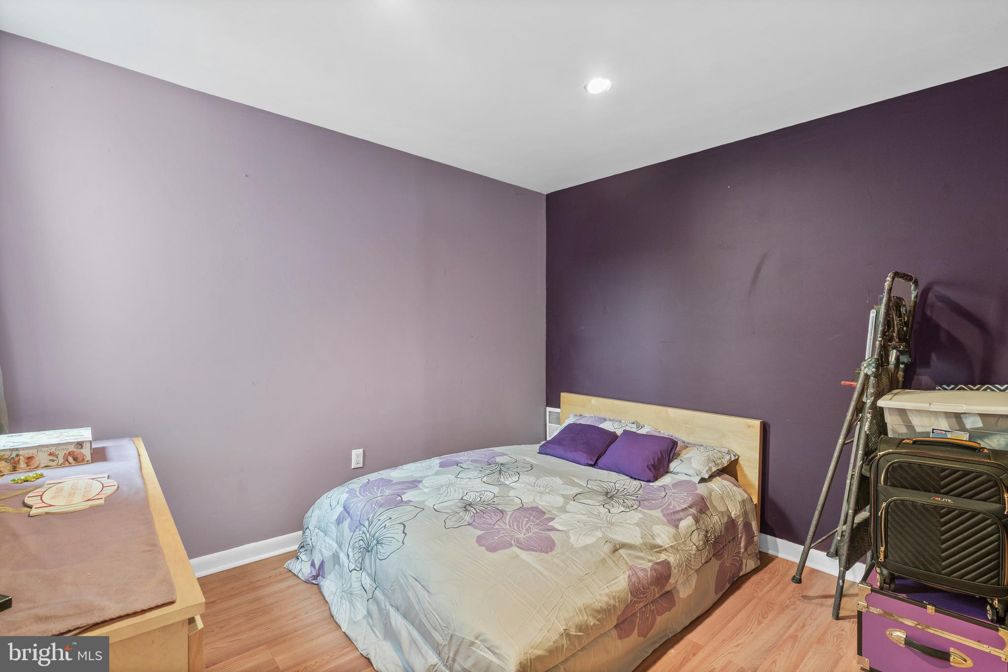 1605 Wolf Street Philadelphia, PA 19145 - Photo 34 of 40 a bedroom with a bed and wooden floor