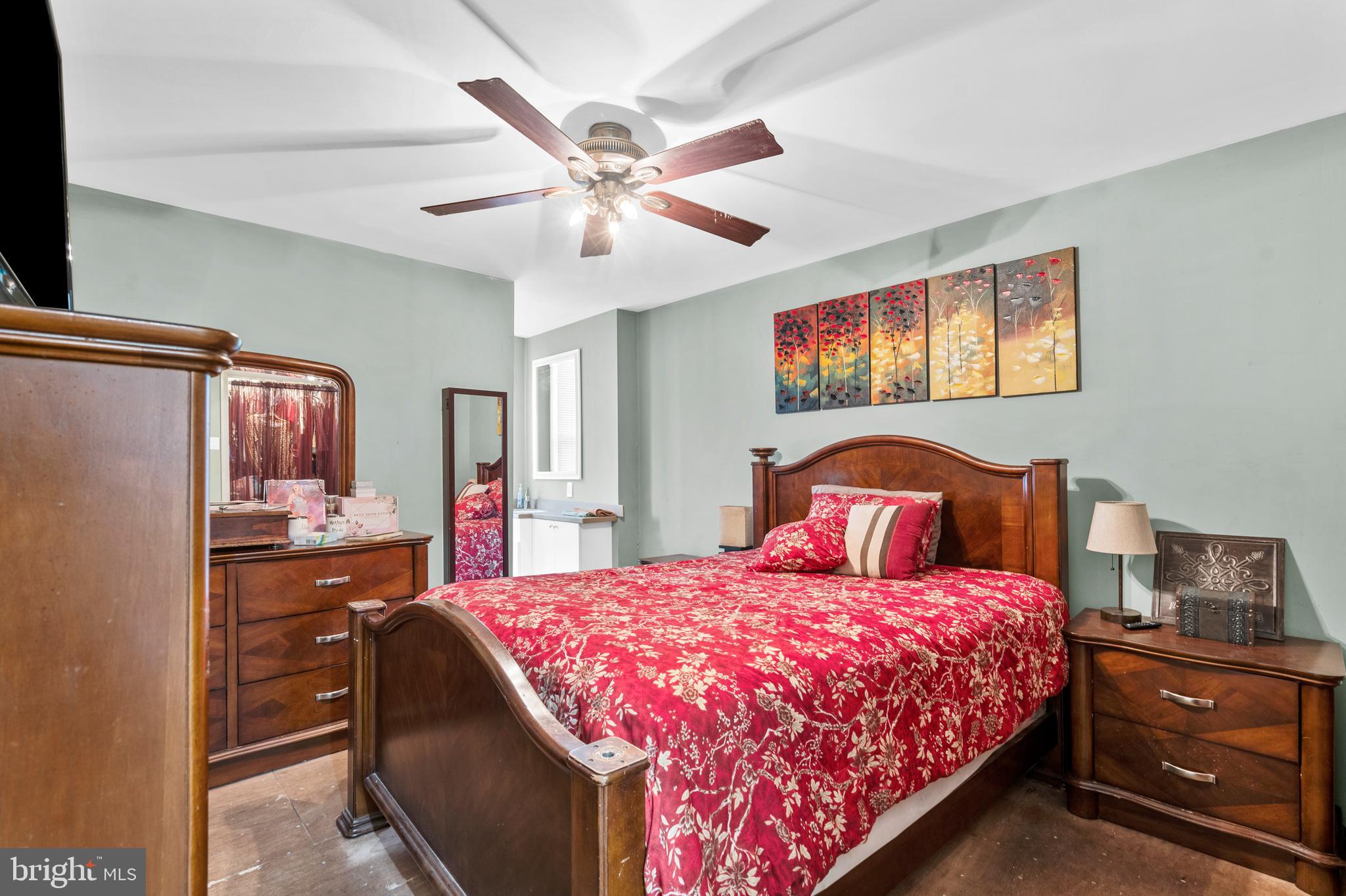 1605 Wolf Street Philadelphia, PA 19145 - Photo 35 of 40 a bedroom with a bed and a chandelier