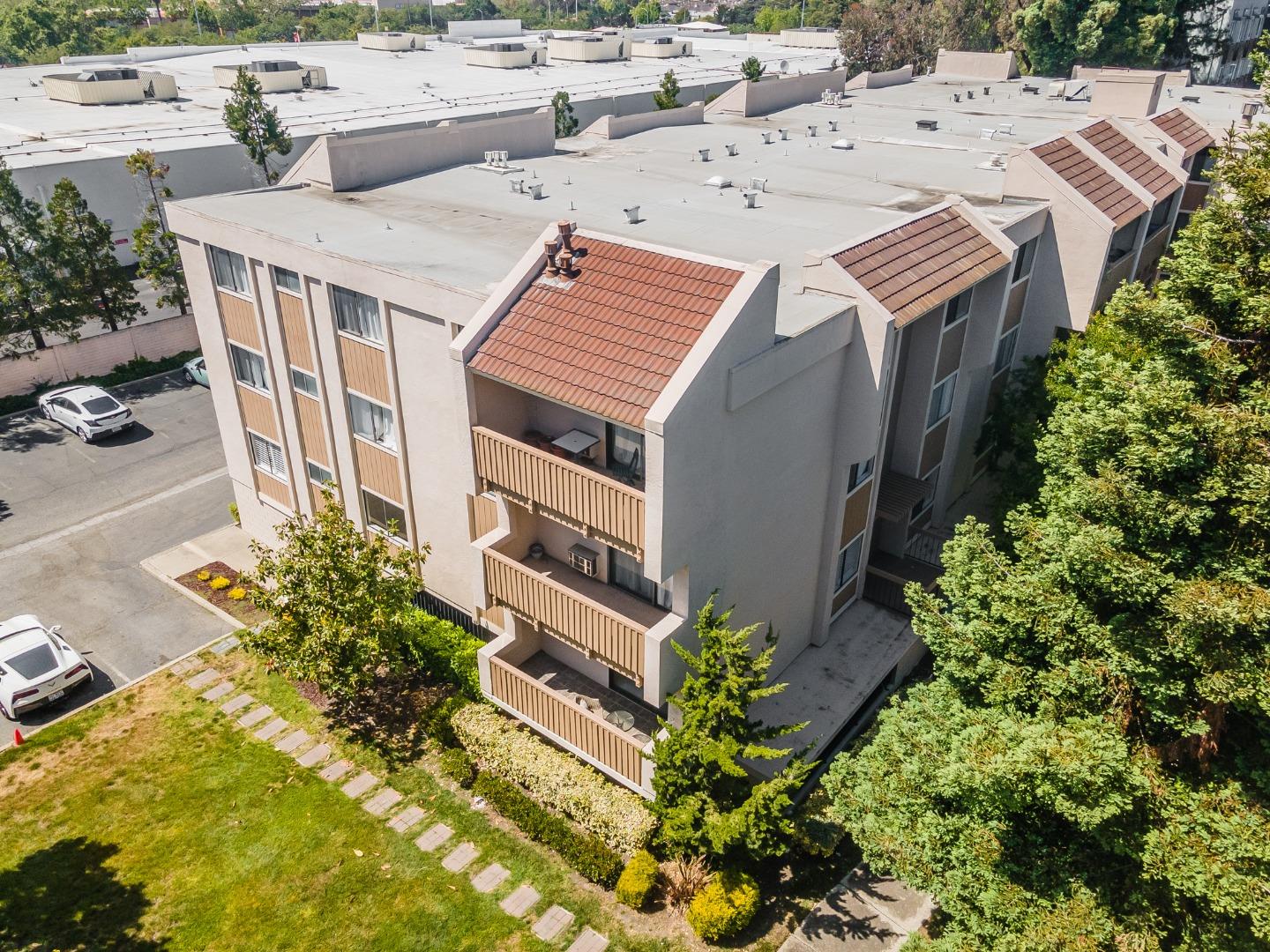 an aerial view of a house with a yard and seating space