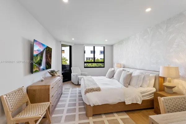 a bedroom with a bed and a couch