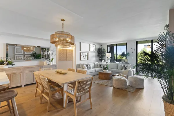 a dining room with furniture a livingroom and chandelier