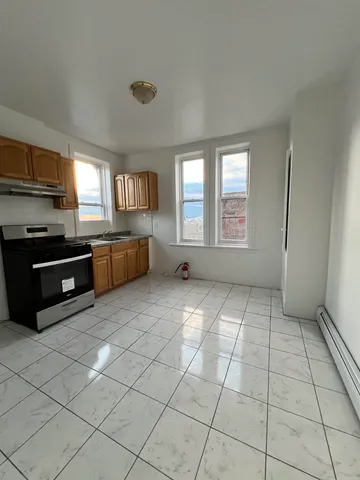 a large kitchen with a stove a sink dishwasher and a refrigerator
