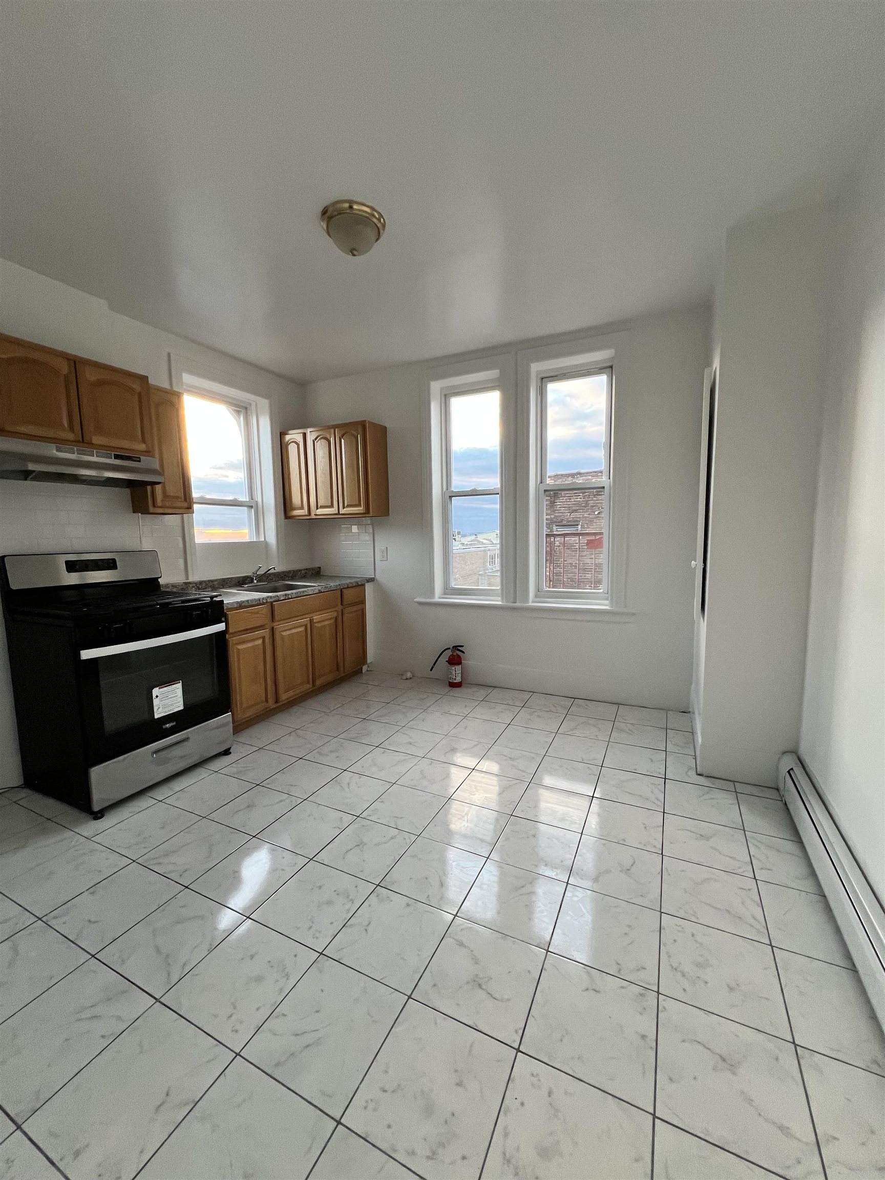 1201 John F. Kennedy Boulevard, Unit 4 North Bergen, NJ 07047 - Photo 3 of 13 a large kitchen with a stove a sink dishwasher and a refrigerator