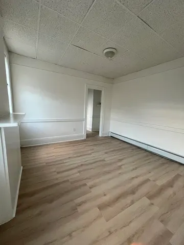 a view of an empty room and wooden floor
