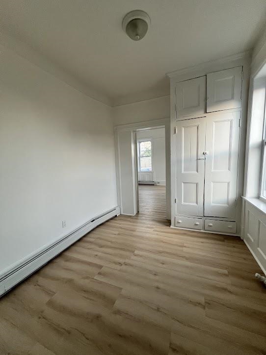 1201 John F. Kennedy Boulevard, Unit 4 North Bergen, NJ 07047 - Photo 8 of 13 an empty room with wooden floor and windows