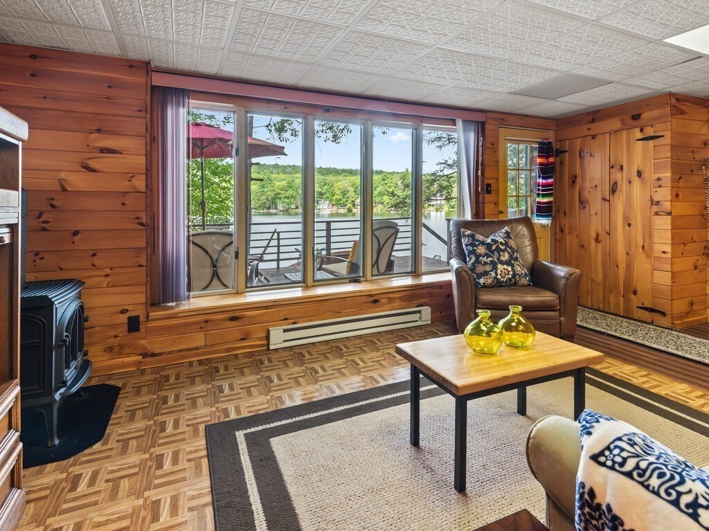 61 Bennetts Road Sturbridge, MA 01566 - Photo 26 of 42 a living room with furniture and a floor to ceiling window
