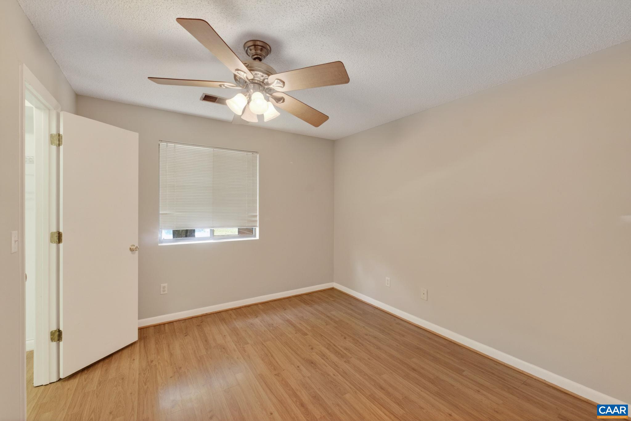 103 Turtle Creek Road, Unit 8 Charlottesville, VA 22901 - Photo 18 of 37 a view of an empty room with wooden floor and a window