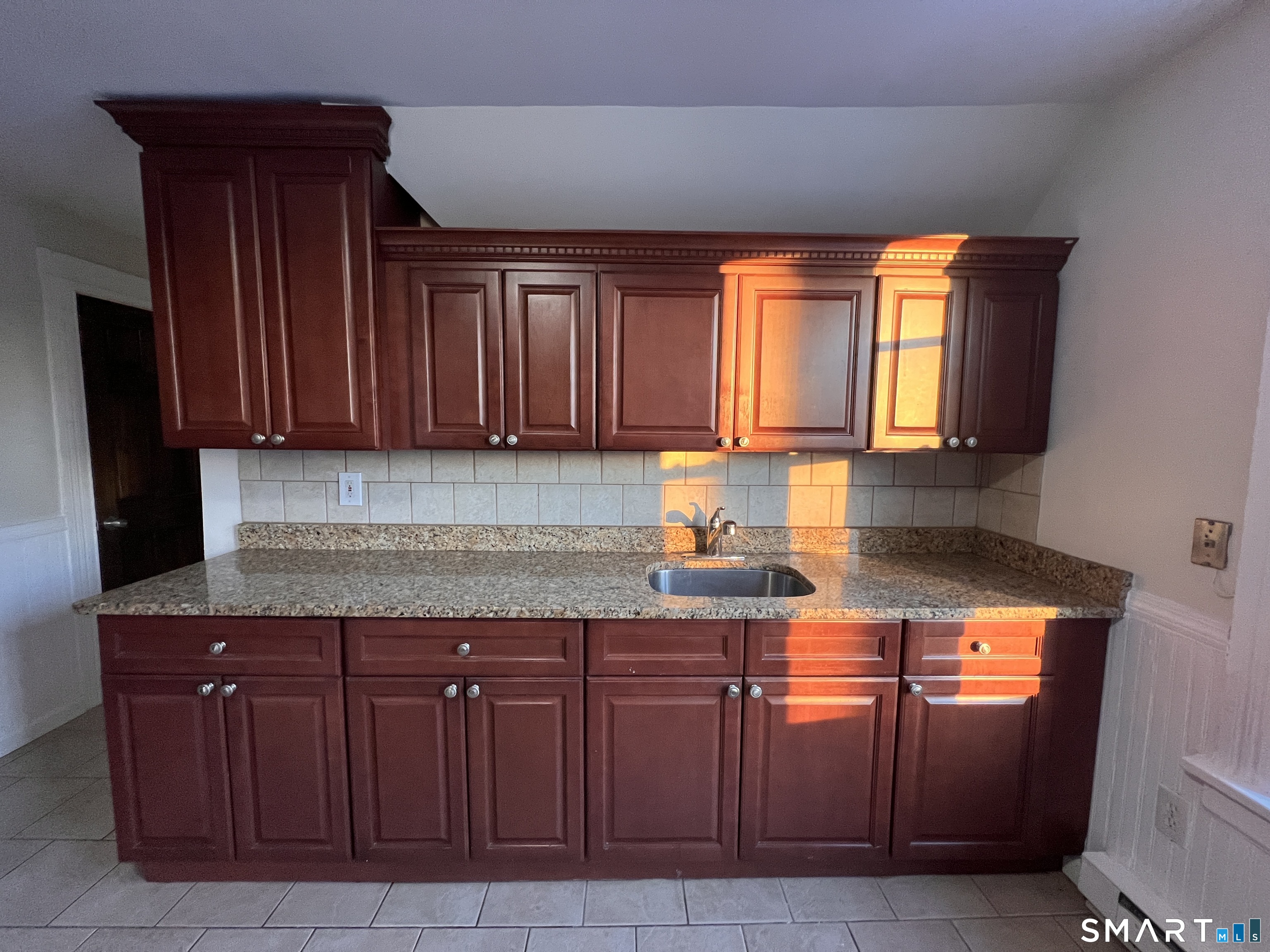 128 Prince Street Bridgeport, CT 06610 - Photo 11 of 19 a kitchen with granite countertop wooden cabinets
