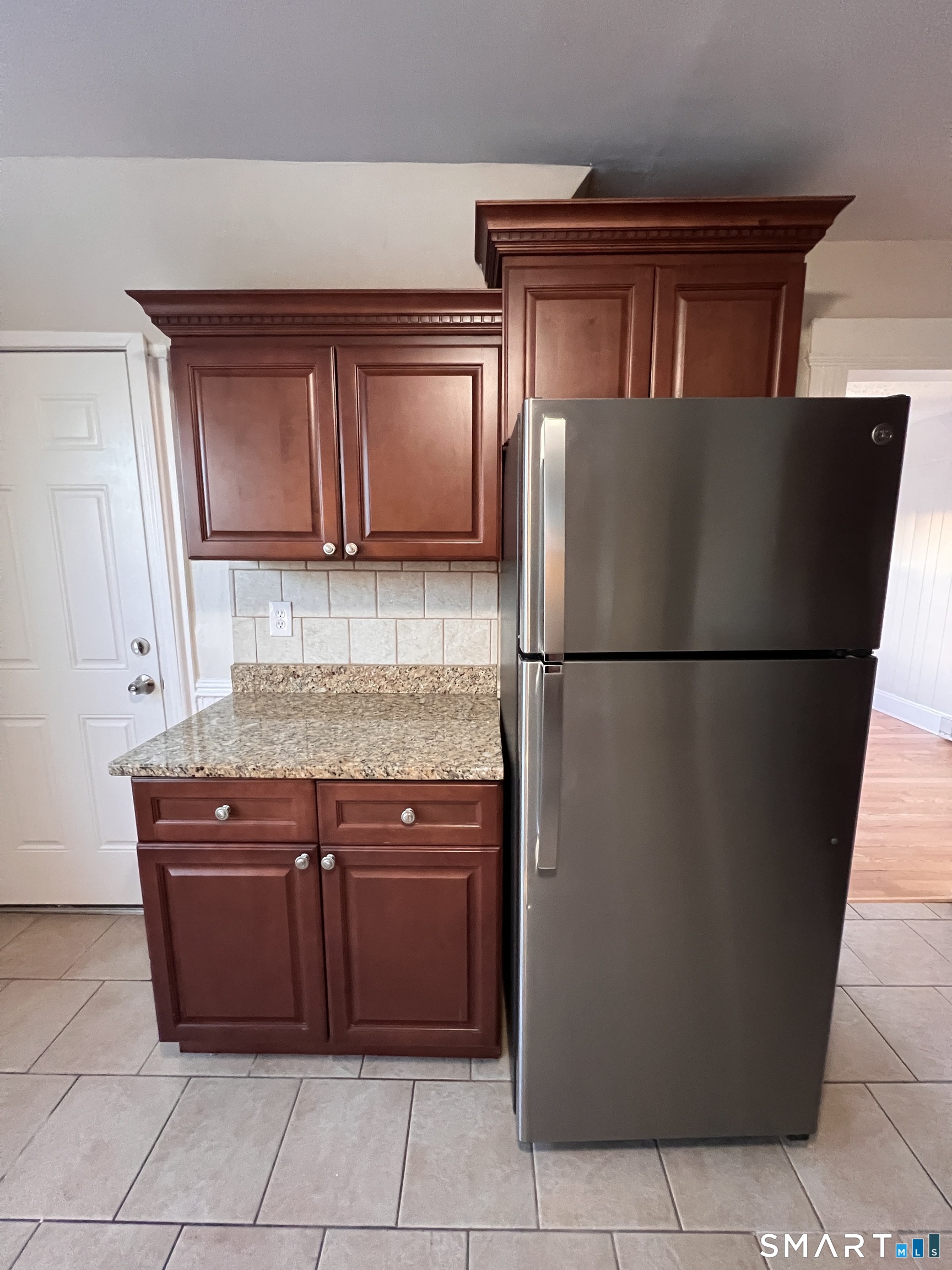 128 Prince Street Bridgeport, CT 06610 - Photo 13 of 19 a kitchen with stainless steel appliances granite countertop a refrigerator and a cabinets