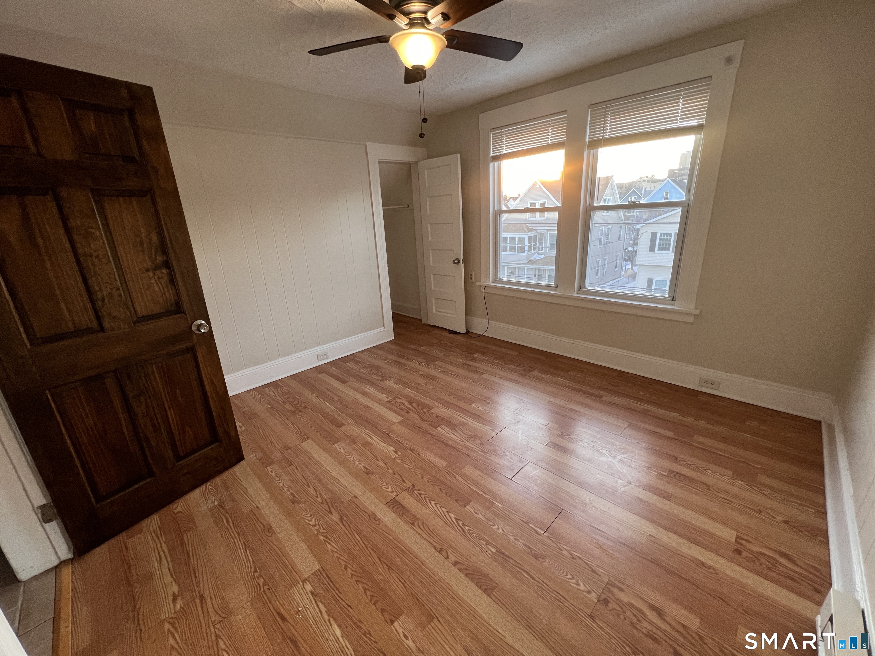 128 Prince Street Bridgeport, CT 06610 - Photo 5 of 19 a view of an empty room with wooden floor and a window