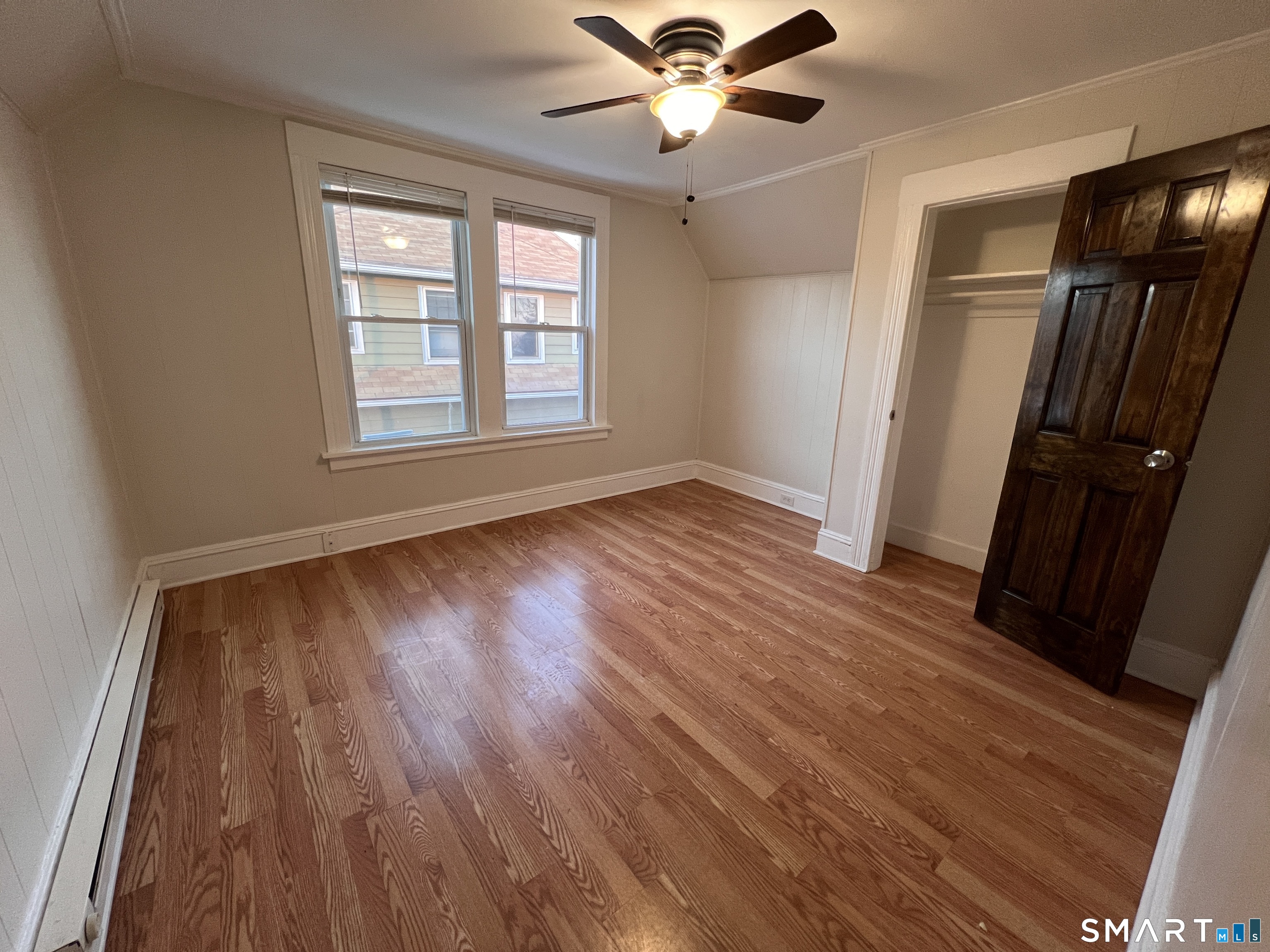 128 Prince Street Bridgeport, CT 06610 - Photo 7 of 19 a view of an empty room with wooden floor and a window